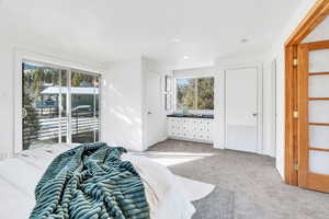 Primary bedroom with doors leading to balcony