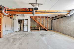 Two car garage below ADU with stairs leading up to entrance