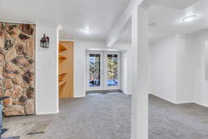 Basement living room with french doors leading to backyard