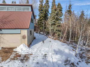 West side of garage/ADU with additional uncovered parking