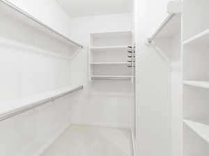 Walk in closet featuring light carpet