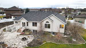 Rear view of house with a residential view, a patio, stucco siding, roof with shingles, and french doors