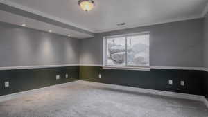 Unfurnished room with carpet and ornamental molding