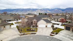 View of front of home featuring a fenced backyard, a residential view, a mountain view, and concrete driveway