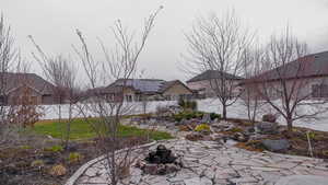 Fenced backyard with an outdoor fire pit and a patio area