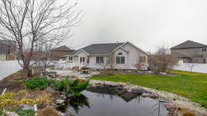 Rear view of property with a shingled roof and a patio