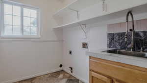 Washroom with hookup for a washing machine, hookup for an electric dryer, and gas dryer hookup