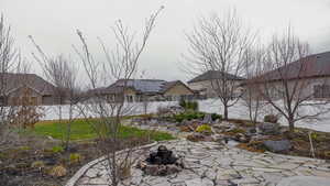 Fenced backyard with an outdoor fire pit and a patio area