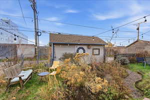 View of outbuilding with a fenced backyard