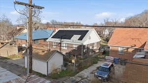 Rear view of property featuring brick siding