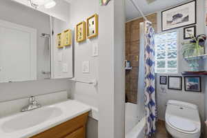Full bath with vanity, shower / bath combo, and tile patterned floors