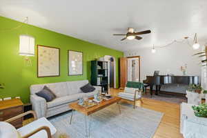 Living room with wood finished floors and ceiling fan