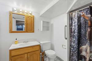 Full bath featuring a shower with shower curtain and vanity