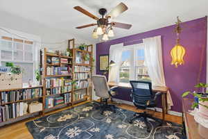 Home office with wood finished floors and ceiling fan