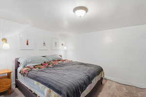 Carpeted bedroom featuring baseboards