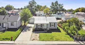 Bungalow featuring a residential view, covered porch, and driveway