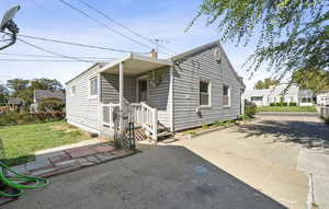 View of front of property with a front yard and a chimney