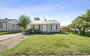 View of front of property featuring covered porch and a chimney