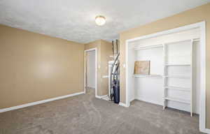 Unfurnished bedroom featuring a closet and carpet