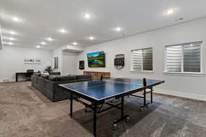 Game room with carpet floors and recessed lighting