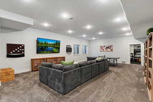 Living area with recessed lighting, carpet floors, and a textured ceiling