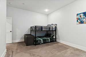 Carpeted bedroom featuring baseboards