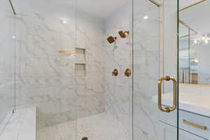 Bathroom featuring a stall shower and vanity