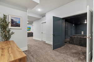 Hallway featuring dark carpet and recessed lighting