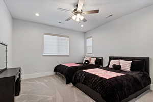 Bedroom with light colored carpet, a ceiling fan, and recessed lighting