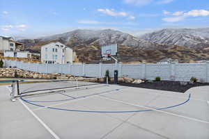 View of sport court featuring basketball hoop and a mountain view