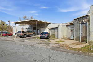 View of parking with a garage and a carport