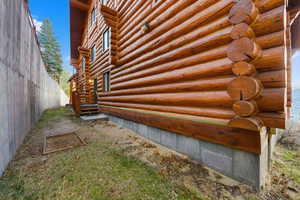 Back of home featuring horseshoes pit