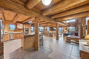 Large, rustic kitchen open to dining and living room