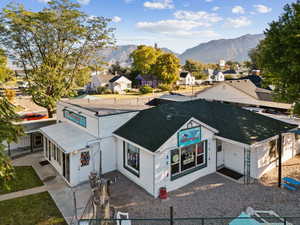 View of front facade with a shingled roof, a residential view, and a mountain view