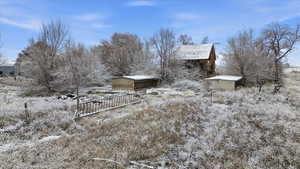 View of snow covered exterior featuring an outdoor structure