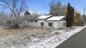 View of snow covered rear of property