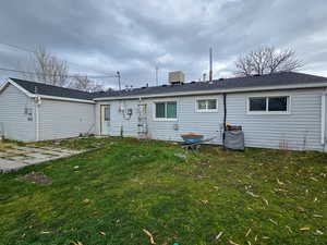 Rear view of property featuring a lawn