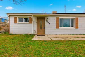 Single story home featuring a front yard and a chimney