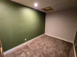 Carpeted empty room featuring recessed lighting and a textured ceiling