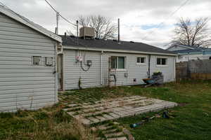 Back of property with a patio and a shingled roof
