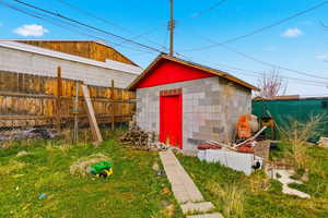 View of outdoor structure featuring a fenced backyard