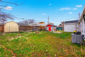Fenced backyard with a storage unit