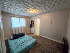Bedroom featuring carpet floors and baseboards