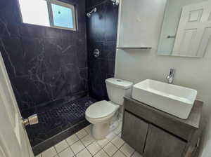 Bathroom with vanity, a stall shower, and tile patterned floors