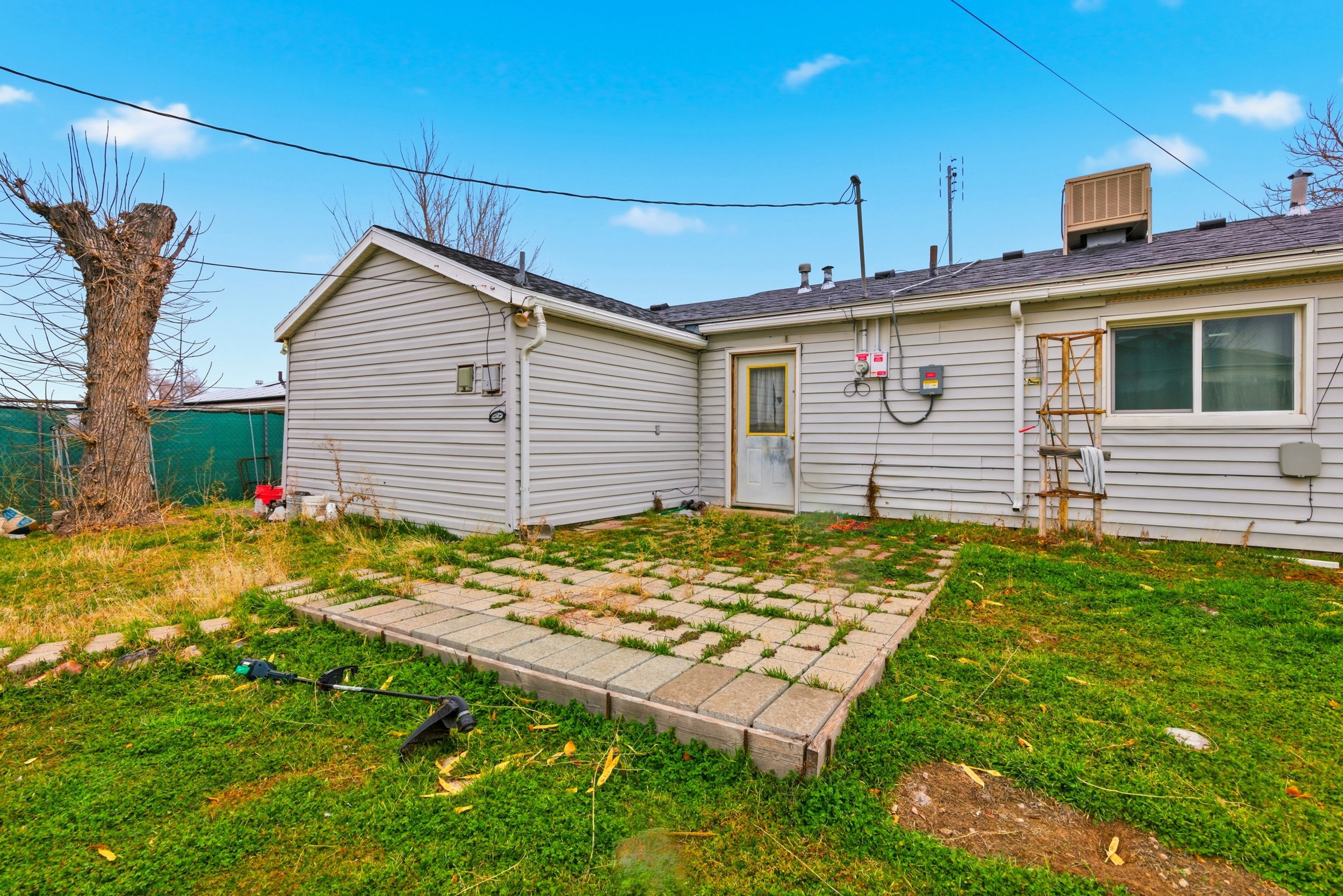 Rear view of property featuring a lawn and a patio