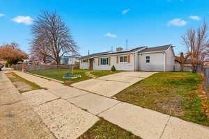 View of front of property with solar panels and concrete driveway