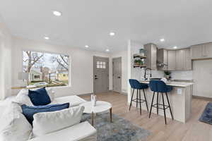 Living area with recessed lighting and light wood finished floors