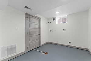 Laundry room with finished concrete floors, electric dryer hookup, washer hookup, and recessed lighting