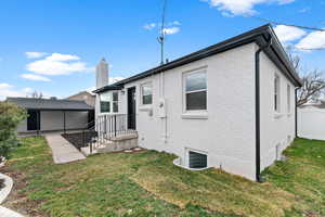 Back of property with brick siding and a chimney
