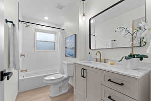 Full bathroom with vanity, shower / bath combo, wood tiled floors, and recessed lighting